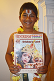  London boy holding Hinduism Today